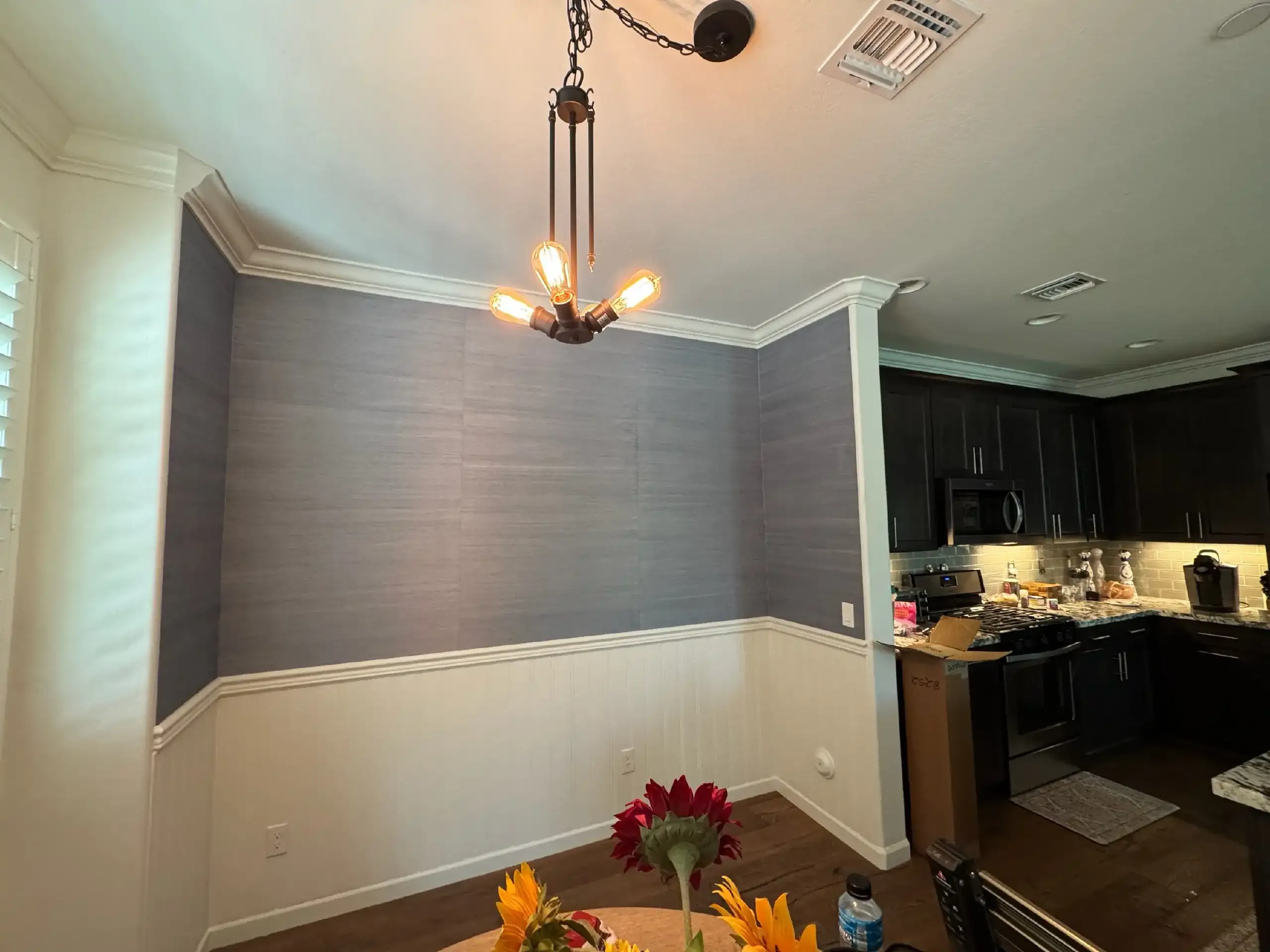 Textured gray wallpaper covering a living-room accent wall
